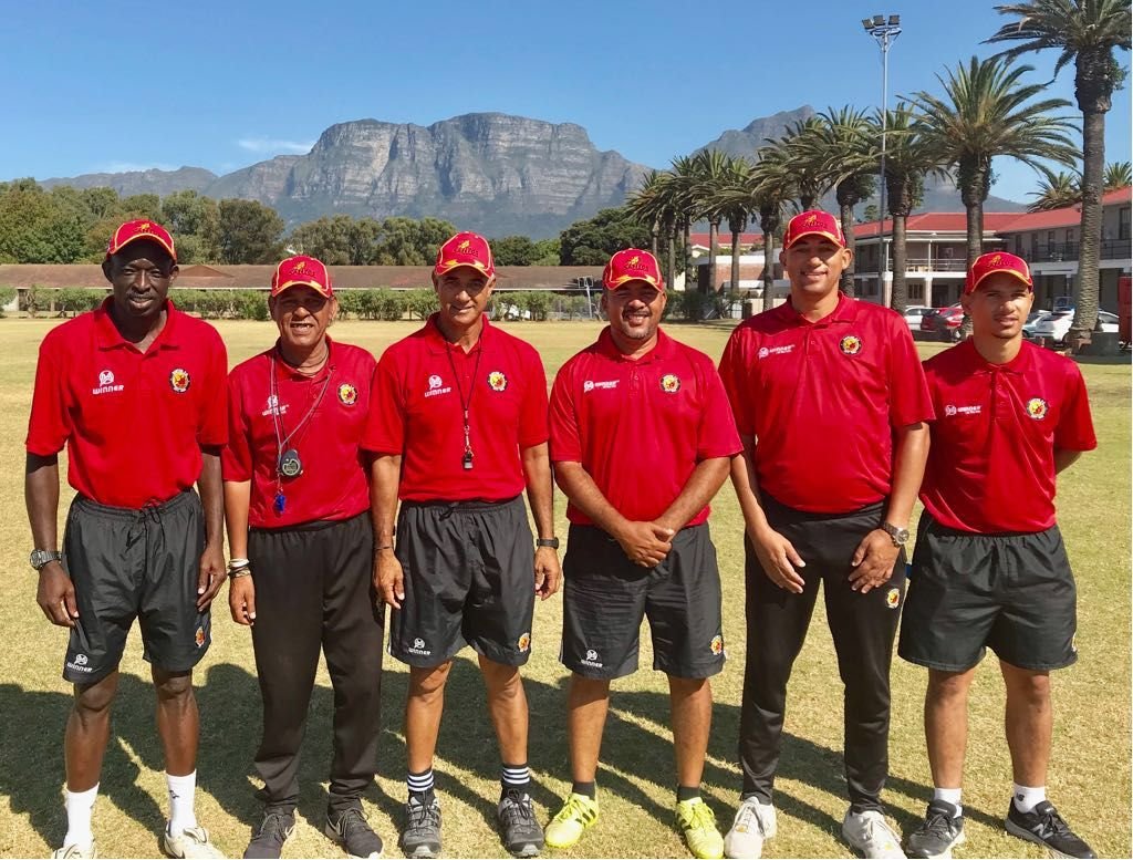 Santos FC coaching staff pictured pitch-side with Table Mountain in the background